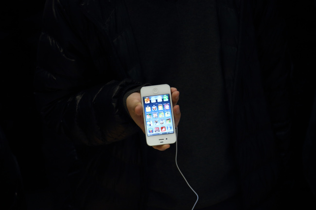 A customer tries an iPhone 5 at Apple’s store Beijing.   Bloomberg