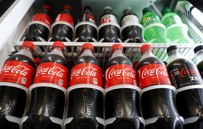 Bottles of Coca-Cola Co. brand soda are displayed for sale at a convenience store in Redondo Beach, California, U.S., on Monday, July 15, 2013. The Coca-Cola Co. is scheduled to release earnings data on July 16. Photographer: Patrick Fallon/Bloomberg
Bottles of Coca-Cola are displayed at a convenience store in Redondo Beach, California, Monday.   Bloomberg
