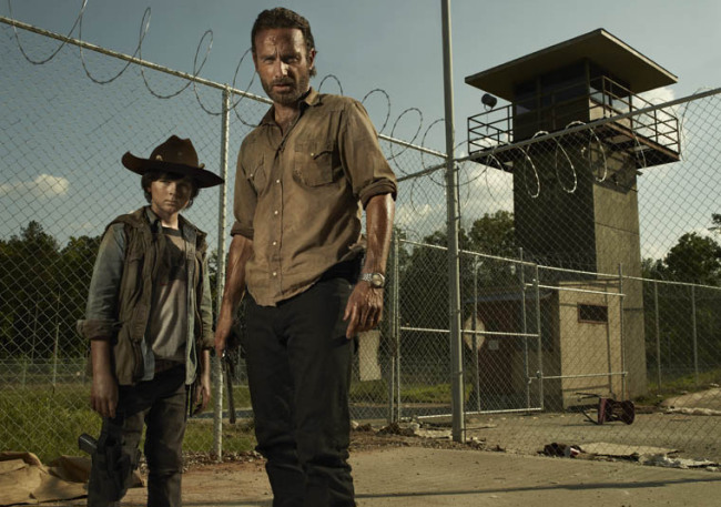 Actors Chandler Riggs (left)  and Andrew Lincoln pose for a promotional shot for “The Walking Dead.”   AMC