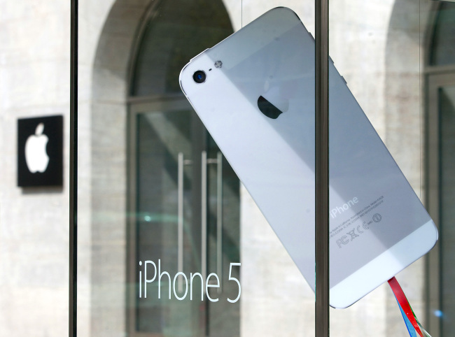 A mock oversized Apple Inc. iPhone 5 in a display case outside the Apple Inc. store in Berlin.   Bloomberg
A mock oversized Apple Inc. iPhone 5 in a display case outside the Apple Inc. store in Berlin.   Bloomberg