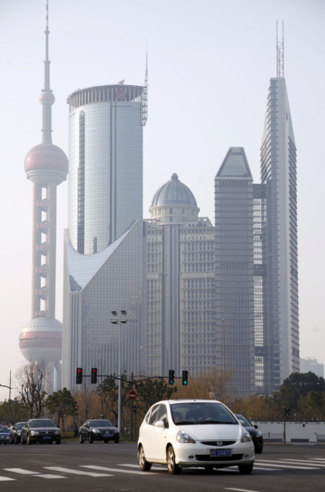 A vehicle travels through the Lujiazui Financial District in Shanghai. Bloomberg