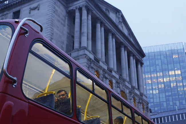 A passenger looks from the window of a London bus as it passes the Bank of England in London.   Bloomberg