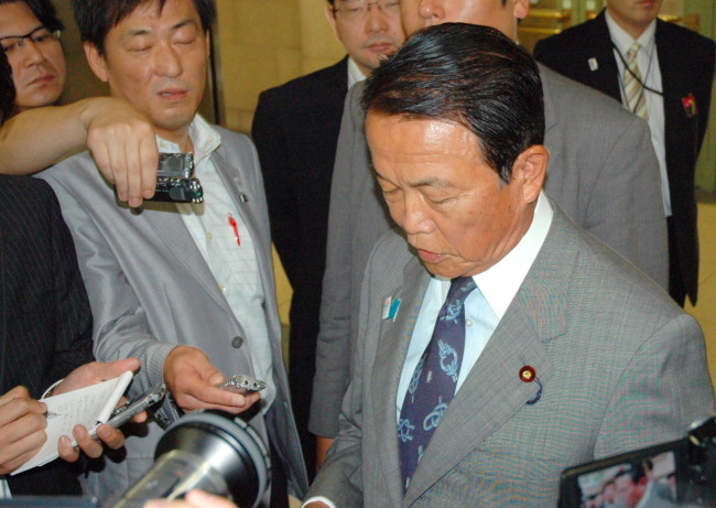 Japan’s Deputy Prime Minister and Finance Minister Taro Aso speaks to reporters at the ministry in Tokyo on Thursday.   AP-Yonhap News