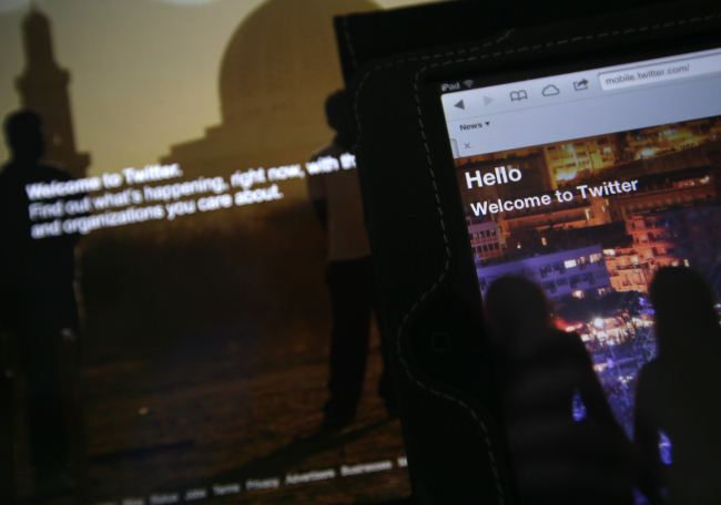Twitter’s homepage is displayed on an iPad and a laptop computer.   AP-Yonhap News