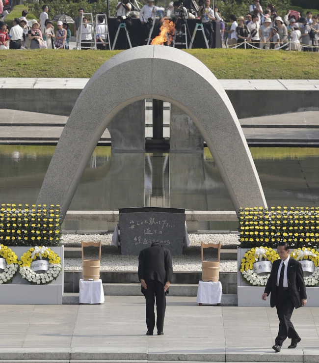 Japanese Prime Minister Shinzo Abe bows in front of the cenotaph dedicated to the victims of the atomic bombing at the Hiroshima Peace Memorial Park during the ceremony to mark the 68th anniversary of the bombing, in Hiroshima, Japan, Tuesday.   AP-Yonhap News
