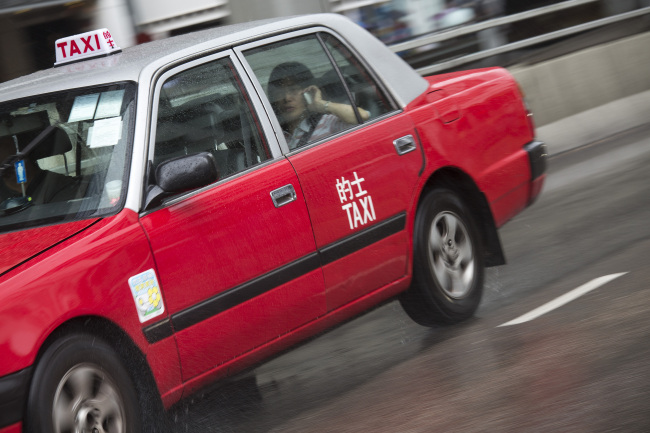 A taxi travels along a road in Hong Kong.   Bloomberg