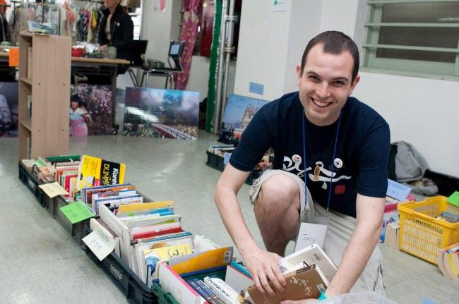 A volunteer helps prepare books to sell for a fund-raiser for the Gwangju International Center’s relocation.   GIC