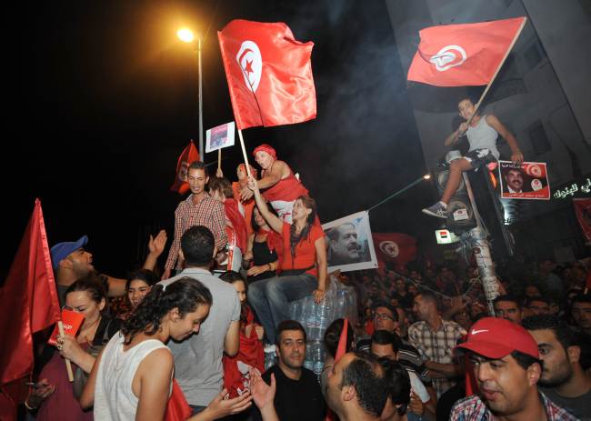 Tunisians chant slogans in front of the National Constituent Assembly in Tunis on Tuesday.   AFP-Yonhap News
