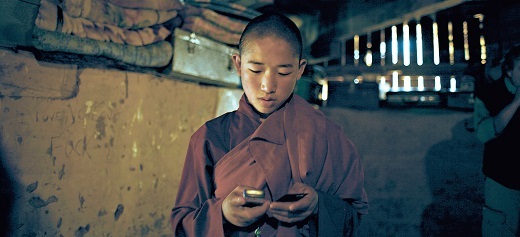 A young monk dials a number on his mobile phone inside the Pangrizampa School of Calculations in Thimphu, Bhutan. (Bloomberg)