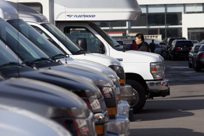A man looks at vehicles at a car market in Beijing.   Bloomberg