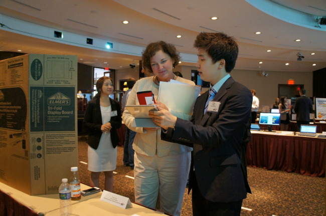 A Korean intern explains his project to an Amway official at the head office in Michigan.   Amway Korea