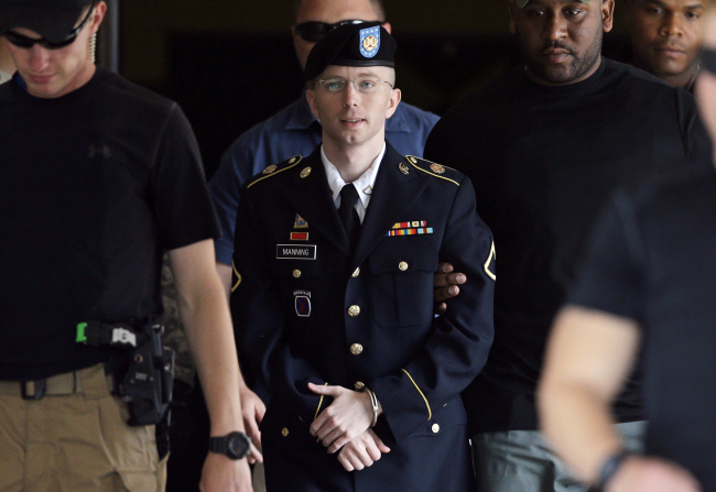 U.S. Army Pfc. Bradley Manning is escorted out of a courthouse in Fort Meade, Maryland, on July 30.   AP-Yonhap News