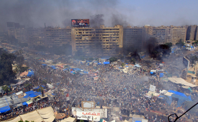 Smoke rises at Rabaa al-Adawya Square following clashes between Egyptians supporting ousted President Mohammed Morsi and riot police in Cairo on Wednesday.   UPI-Yonhap News