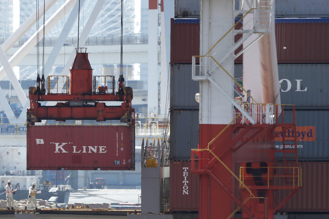 A Kawasaki Kisen Kaisha Ltd. “K” Line shipping container is loaded onto a container ship at a shipping terminal in Yokohama, Kanagawa prefecture, Japan, Sunday.    Bloomberg