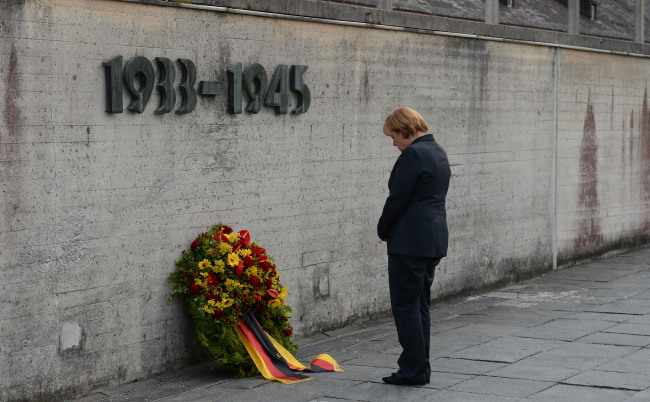 German Chancellor Angela Merkel attends a wreath-laying ceremony during her visit to the concentration camp in Dachau in southern Germany on Tuesday. (AP-Yonhap News)