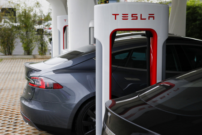 A Tesla Motors Inc. vehicle is charged at the company’s design studio in Hawthorne, California.   Bloomberg