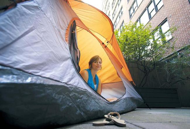 Kathleen Boyle poses for a picture in a tent on the patio of her room at the Affina Hotel in New York. (AP-Yonhap News)
