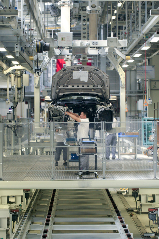 Employees at the BMW Brilliance Automotive Ltd. Tiexi plant work on an assembly line in Shenyang, Liaoning province, China.  Bloomberg