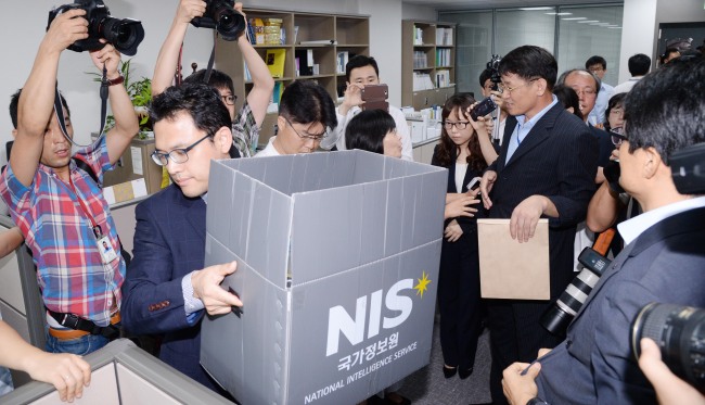 An investigator carries a box of materials seized from the office of Unified Progressive Party Rep. Lee Seok-ki at the National Assembly on Wednesday.   Park Hyun-koo/The Korea Herald