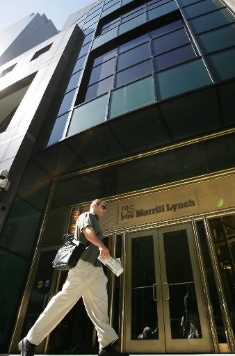 A pedestrian walks past the Merrill Lynch & Co. headquarters in New York.   Bloomberg
