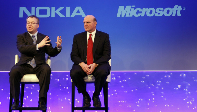 This Feb. 11, 2011 file photo shows Stephen Elop CEO of Nokia, left, with CEO of Microsoft Steve Ballmer, speaking in London. Microsoft says it is buying Nokia's devices and services business, and getting access to the company's patents, for a total of 5.44 billion euros ($7.2 billion) in an effort to expand its share of the smartphone market. (AP-Yonhap News)