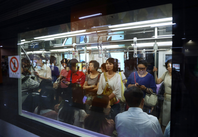 Passengers ride a subway train in Shanghai.   Bloomberg