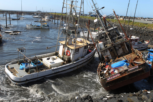 This 2011 file photo shows boats colliding with one another after a tsunami swept through Crescent City, California.   AP-Yonhap News