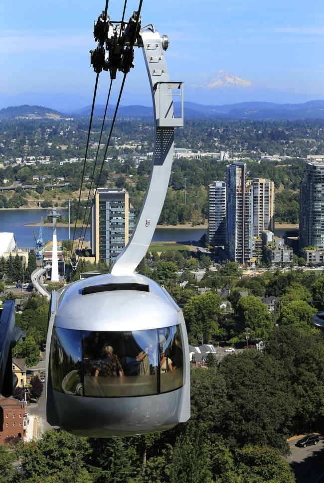Riders enjoy the view of Portland from the Aerial Tram that carries commuters from the city’s Southwest Waterfront to the Oregon Health and Science University Campus, July 30. (Los Angeles Times/MCT)