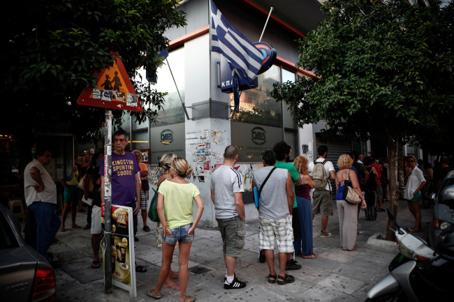 Jobseekers queue to enter a Labor Force Employment Organization job center in Athens.   Bloomberg
