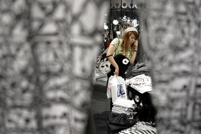 A customer browses clothes at a Monki fashion store at the Cute Cube Harajuku commercial complex in Tokyo on Friday.   Bloomberg