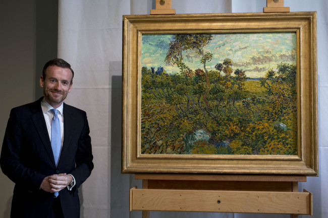 Van Gogh Museum director Axel Rueger (left), poses next to “Sunset at Montmajour” after unveiling the painting by Dutch painter Vincent Van Gogh during a press conference at the museum in Amsterdam, Netherlands, Monday.    AP-Yonhap News