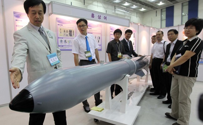 Researchers at the state-run Agency for Defense Development explain Hongsangeo, an anti-submarine torpedo, during an academic forum held at Daejeon Convention Center in August 2010.   Yonhap News