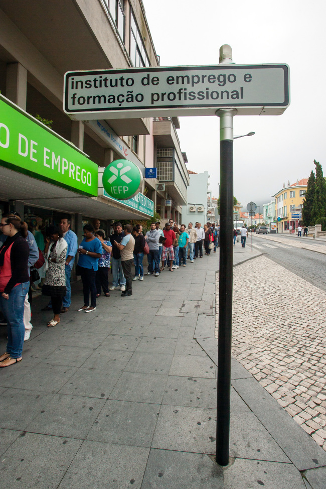 Job seekers queue to enter an employment center in Sintra, Portugal.  Bloomberg
