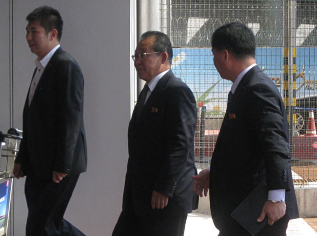 North Korea's chief nuclear negotiator, Kim Kye-gwan, and his aides arrive at a Beijing airport to depart for Pyongyang on Friday after their five-day visit to the Chinese capital.(Yonhap News)