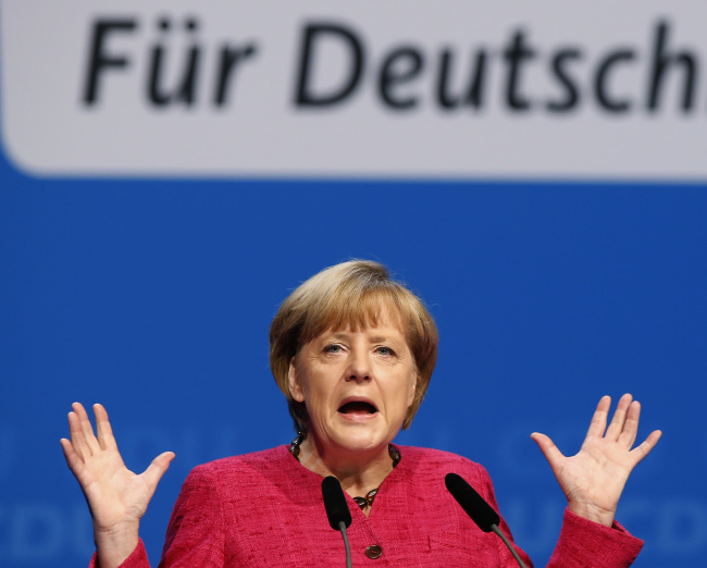 German Chancellor and chairwoman of the German Christian Democratic Union Angela Merkel speaks during the last stage of the election campaign in Berlin on Saturday.   AP-Yonhap News