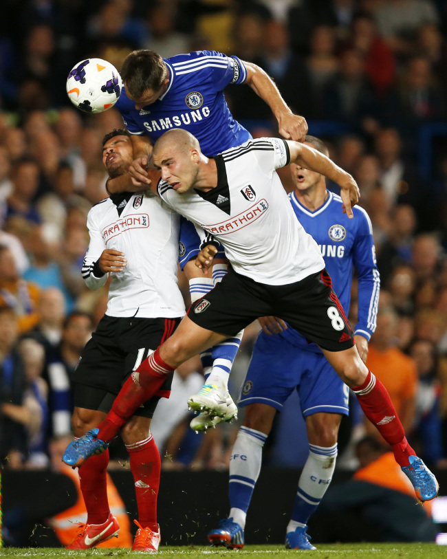John Terry (top) of Chelsea heads the ball during the Barclays Premier League match between Chelsea and Fulham at Stamford Bridge Stadium in London on Saturday.   Xinhua-Yonhap News