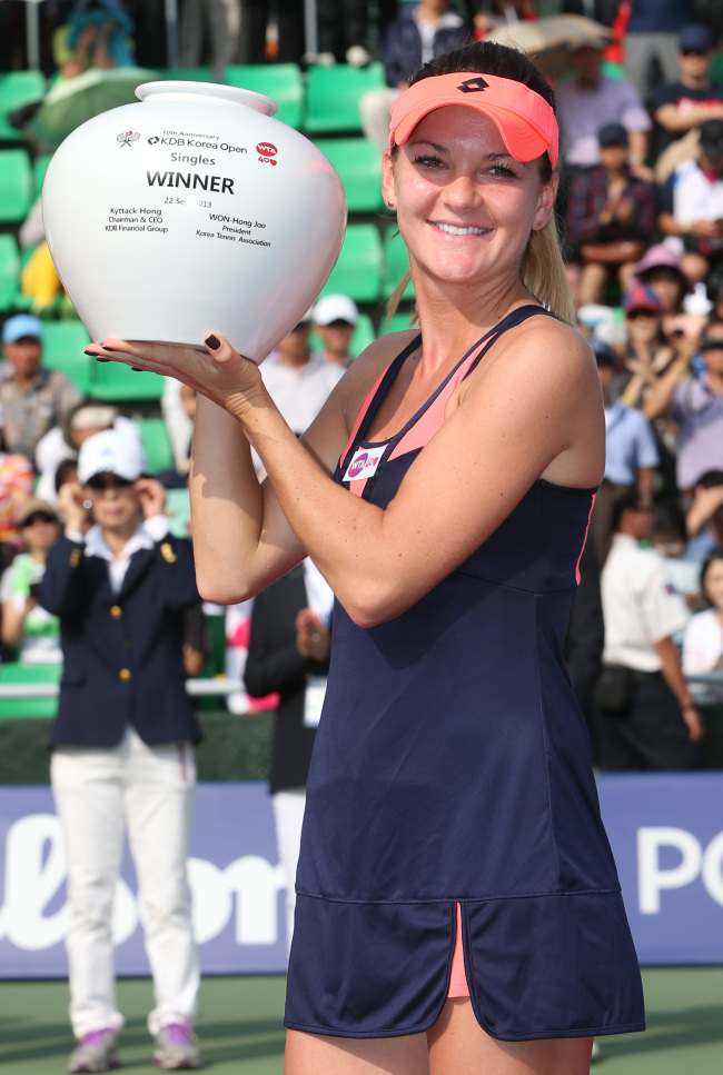 Agnieszka Radwanska holds the trophy after winning the KDB Korea Open in Seoul on Sunday.   Yonhap News