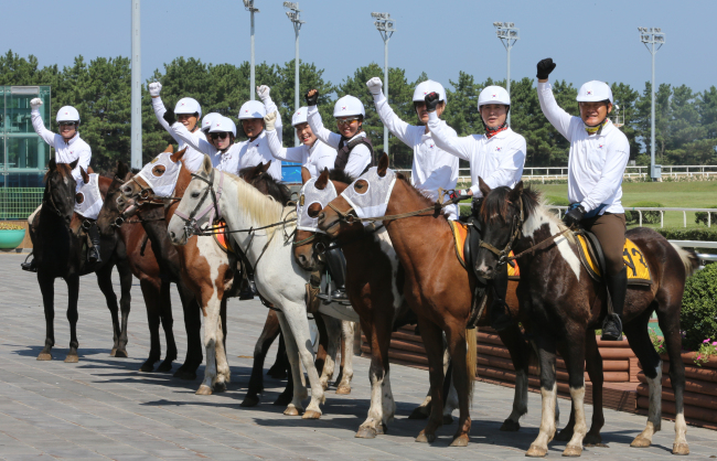 Riders pose before starting a cross-country journey at Jeju Race Park on Jejudo Island on Monday. (Yonhap News)
