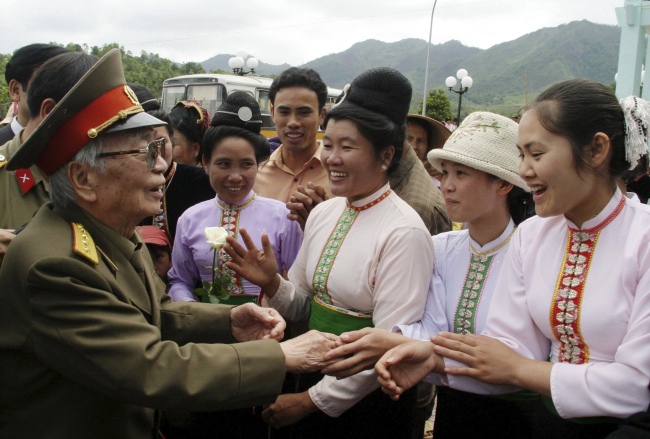 Vietnamese local minority women greet Gen. Vo Nguyen Giap during a visit to the historic Dien Phu military headquarters building in Muong Phang, Dien Bien province in this April 19, 2004 file photo.