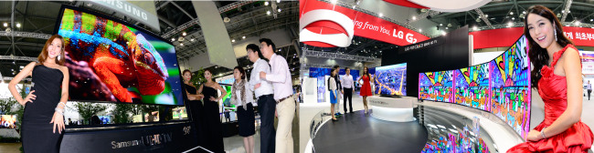 Two global tech giants ― Samsung Electronics and LG Electronics ― compete over TV-related high technologies during the Korea Electronics Show 2013, in KINTEX, Ilsan, west of Seoul on Monday. Samsung showcased ultra-high definition TV while LG promoted its curved OLED TV.   Park Hae-mook/The Korea Herald