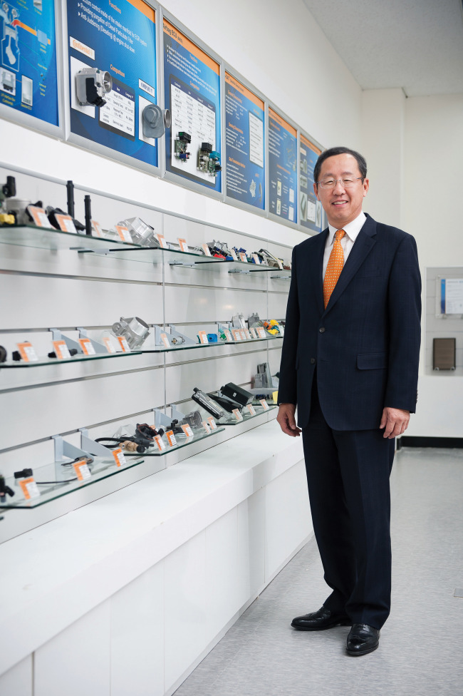Sunwoo Hyun, CEO of Continental Automotive Systems Korea, poses with company products.   Continental Automotive