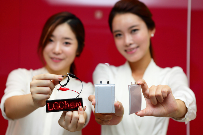 Models pose with cable, stepped and curved batteries at an event on Tuesday.   LG Chem