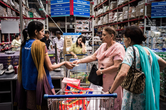 A customer pays at a checkout counter at a Bharti-Walmart Pvt. Ltd. Best Price Modern Wholesale store in Zirakpur, India.    Bloomberg