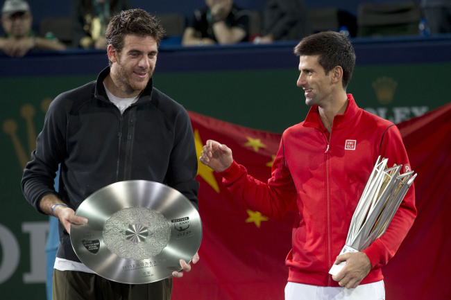 Novak Djokovic (right) celebrates with his trophy after defeating Juan Martin del Potro (left) in their final match of the Shanghai Masters tournament on Sunday.   (AP-Yonhap News)