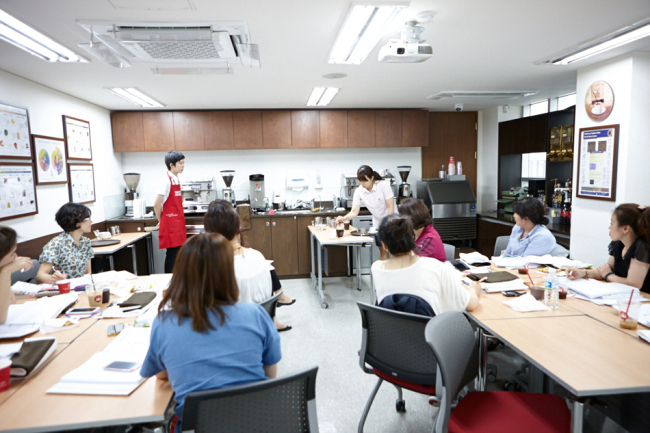 Students attend a coffee-making class at Hollys Coffee Academy.   Hollys Coffee