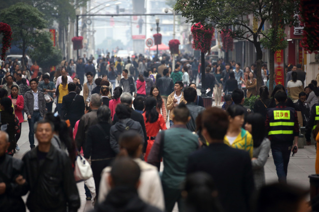 Shoppers walk along a shopping street in Wuhan, China.  Bloomberg