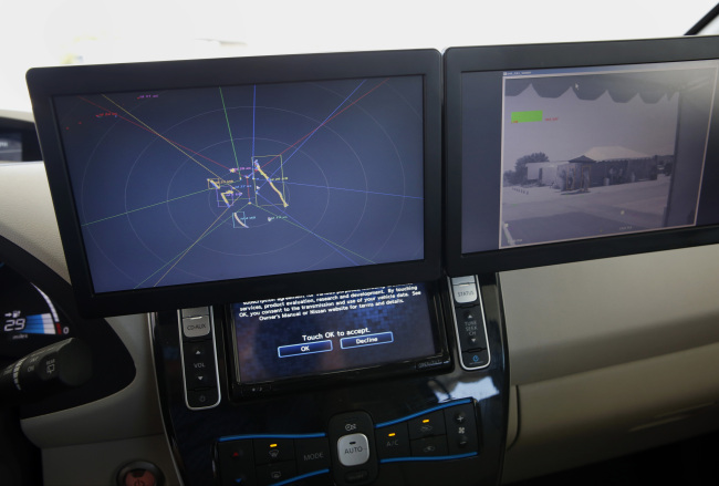 LCD panels show laser sensor and camera sensor information on the Nissan Autonomous Drive Leaf electric vehicle seen on a test track during the Nissan Motor Co. 360 event in Irvine, California.    Bloomberg