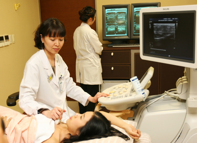 A doctor performs a breast ultrasound at Ewha Womans University Medical Center.   Ewha Womans University Medical Center