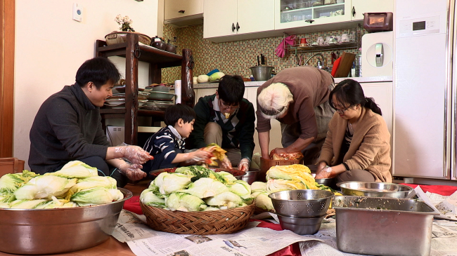 Family members gather to prepare kimchi.   Cultural Heritage Administration