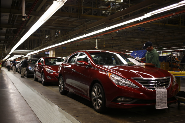 Workers perform a final inspection on Sonata and Elantra vehicles at the Hyundai Motor Manufacturing Alabama assembly plant in Montgomery, Alabama. Bloomberg